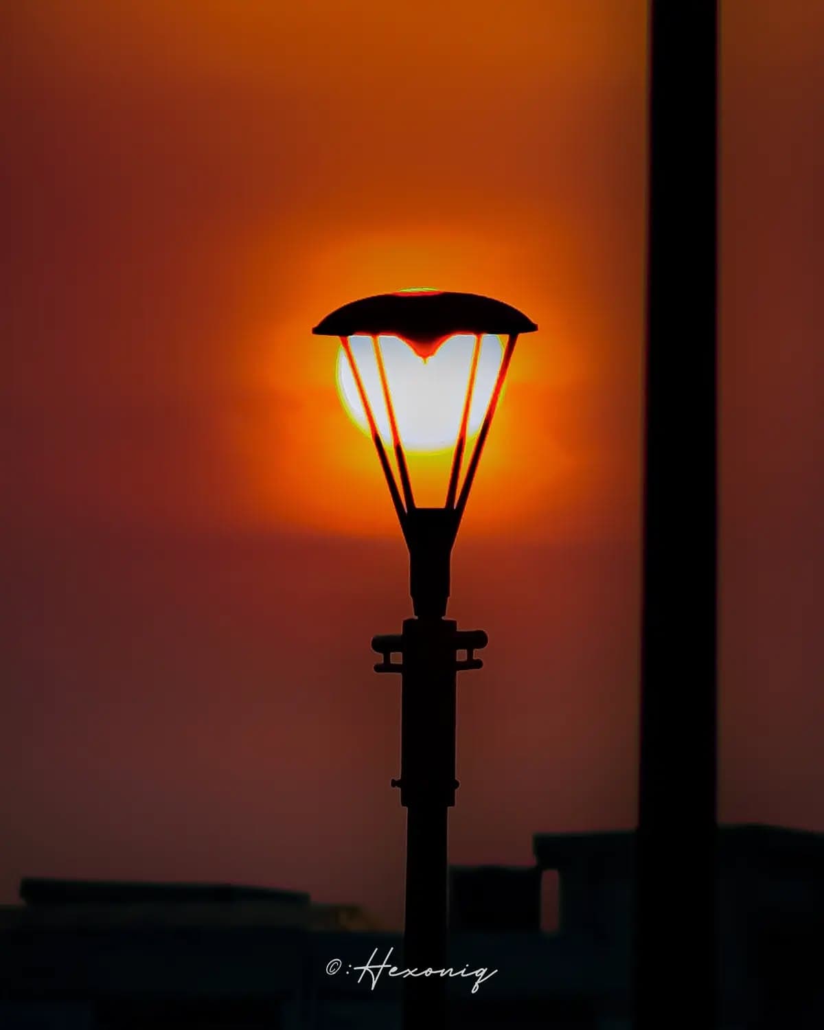 "Street photography is a play of light and darkness, where lamp posts stand sentinel in the drama, c